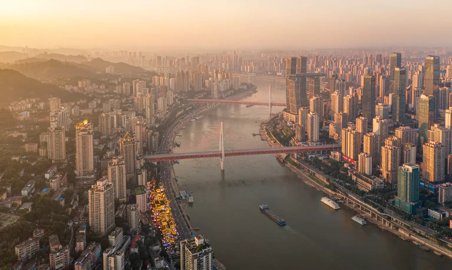 Chongqing's mountainous skyline above the Yangtze and Jialing rivers at dusk