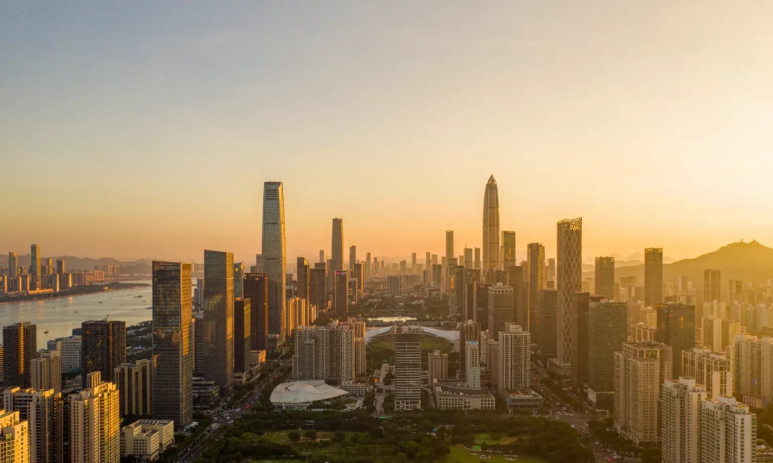 Shenzhen's Futian skyline across Shenzhen Bay at dusk