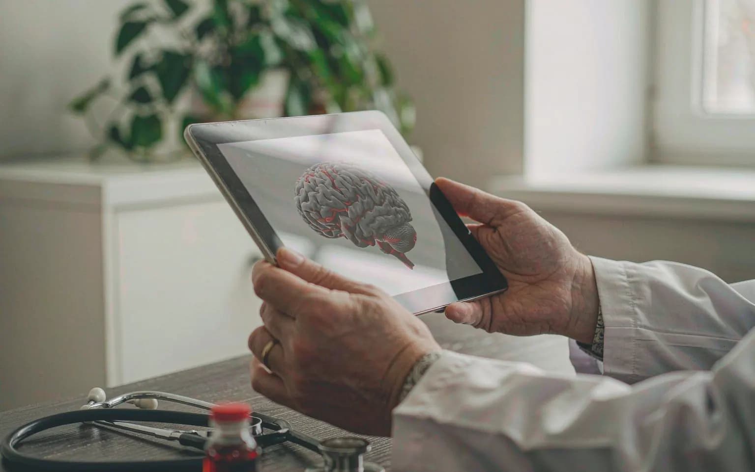 A doctor reviewing medical imaging in a bright consultation room