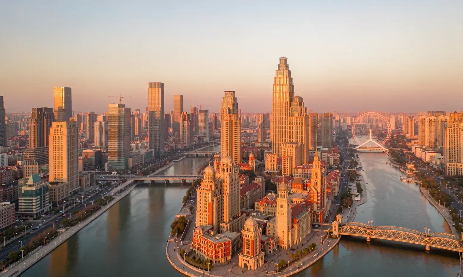 Historic riverside architecture along Tianjin's Hai River at dusk